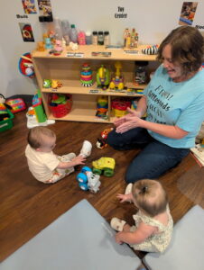 Teacher and infants playing